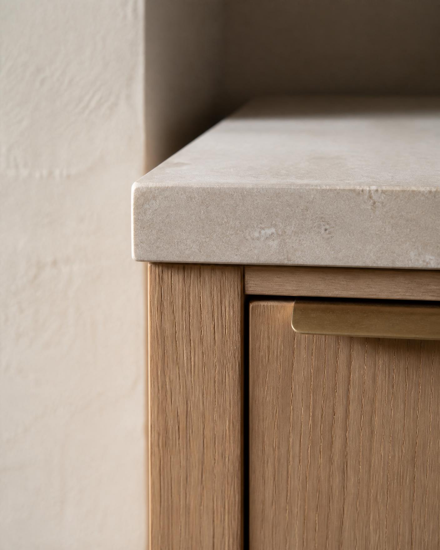 Fine oak cabinetry meeting a honed limestone countertop.